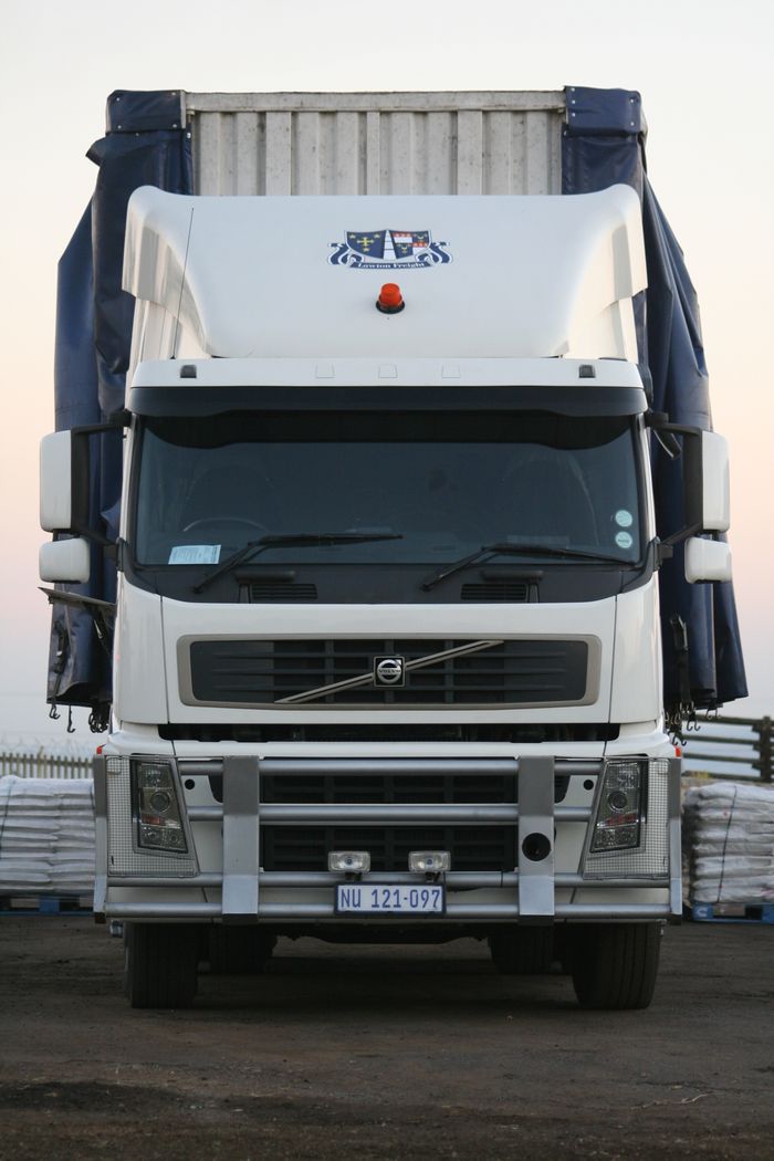 about-07 A powerful white truck captured from the front, showcasing its robust design.