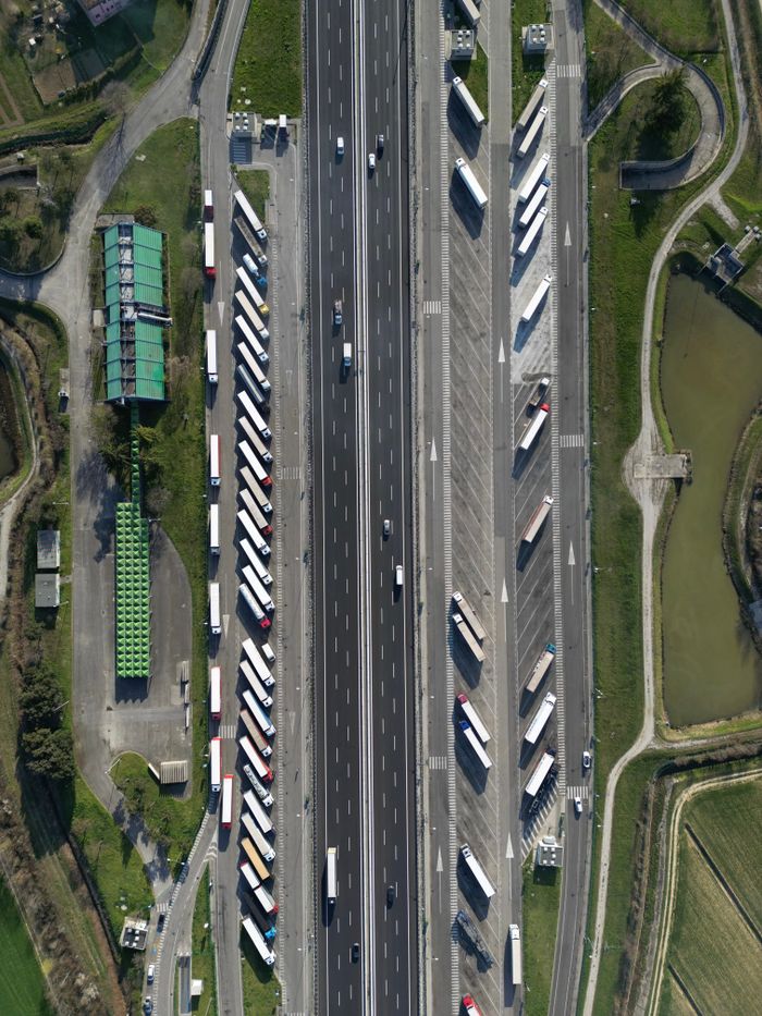 about-05 Highway traffic captured from above showcasing trucks and parked vehicles in Roncade, Italy.